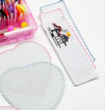 Illustrative stitched bookmark and round fabric project beside a thread box; finished work and accessories are not included