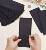 Black blank cross-stitch bookmarks with black stitched borders; needle shown for illustration